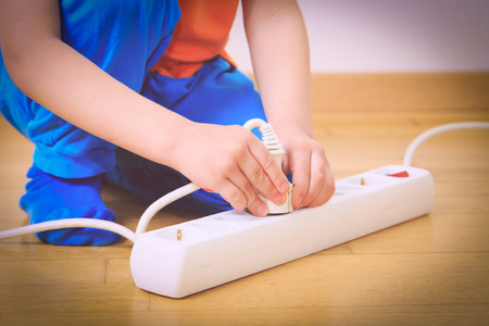 child playing with electricity, kids safety conceptの写真素材
