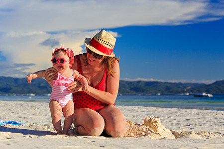 mother and little daughter on tropical sand beachの写真素材