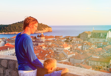 father and son looking at old town Dubrovnik, Croatiaの写真素材