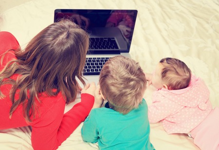 teacher and kids looking at laptop, early education and technologyの写真素材