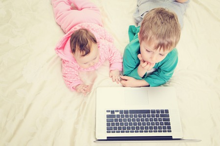 kids looking at laptop, early education and modern technologyの写真素材