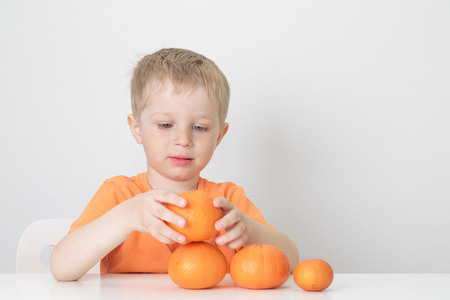 little boy with oranges, healthy food conceptの写真素材