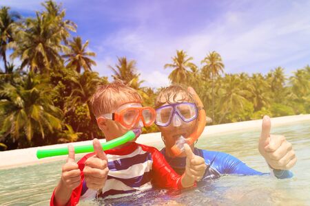 happy father and son snorkeling on tropical beachの写真素材