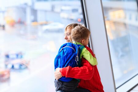 family travel- father and son hug in the airportの写真素材