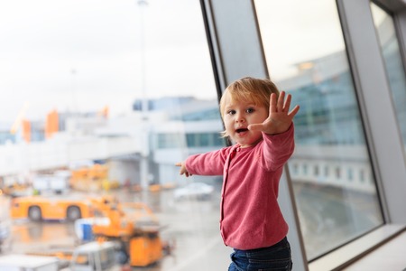 happy cute little girl travel in the airport, kids travelの写真素材