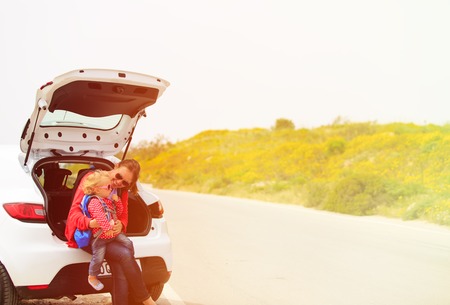 mother and little daughter travel by car in summer natureの写真素材