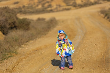 cute little girl with backpack travel on the road, kids travelの写真素材