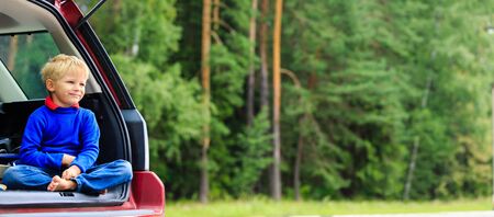 happy little boy travel by car in summer nature, kids travelの写真素材