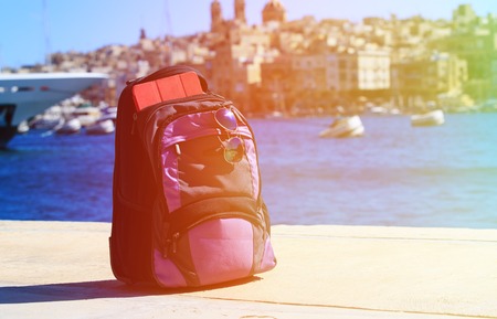 backpack, touch pad and sunglasses in Malta, travel concept
