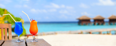 Two cocktails on luxury tropical beach resort, wide panoramaの写真素材
