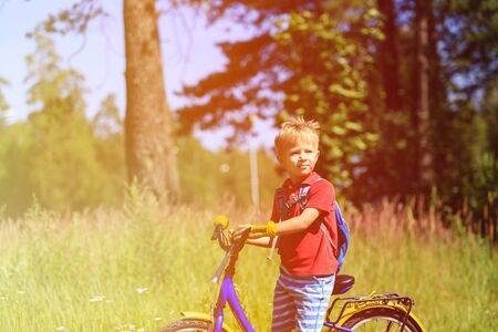 little boy travel by bike in summer nature, kids sportの写真素材