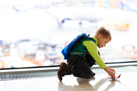 little boy playing with toy plane in the airport, kids travelの写真素材