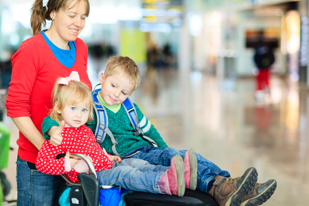 family with two kids travel in the airport, family travelの写真素材