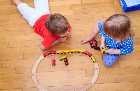 kids playing with railroad and trains indoor, learning and daycareの写真素材