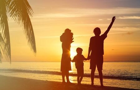 happy family with two kids having fun at sunset beachの写真素材