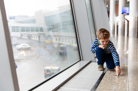 little boy playing with toy plane in the airport, travel conceptの写真素材