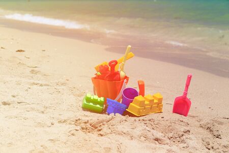 kid toys on tropical sand beach, vacation conceptの写真素材