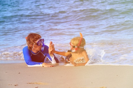happy father and son snorkeling on summer beachの写真素材