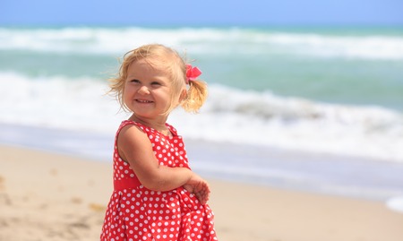 cute little girl at summer sand beachの写真素材