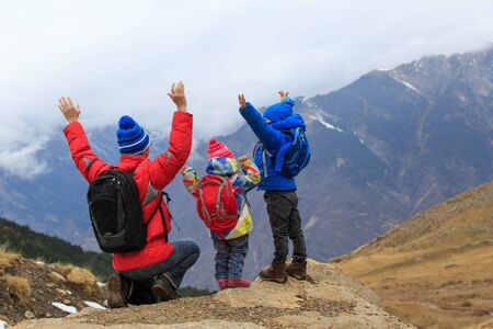 happy father with two kids travel in scenic mountains, family travelの写真素材