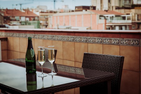 champagne Glasses and bottle served in restaurant with view to Barcelona city center