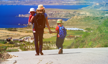 Family travel concept - mother with two kids travel on scenic roadの写真素材