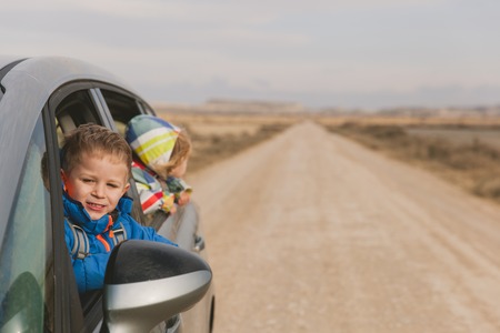 little rland g travel by car on the road, family travelの写真素材