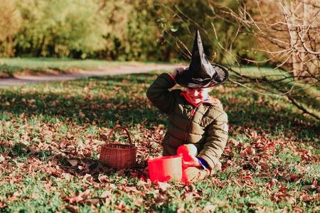 little boy in halloween costume in autumn, kids trick or treatingの写真素材