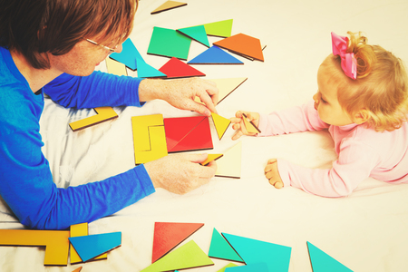 teacher and child playing with geometric shapes, early learning conceptの写真素材