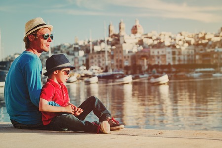 father and son looking at city of Valetta, Malta, family travelの写真素材