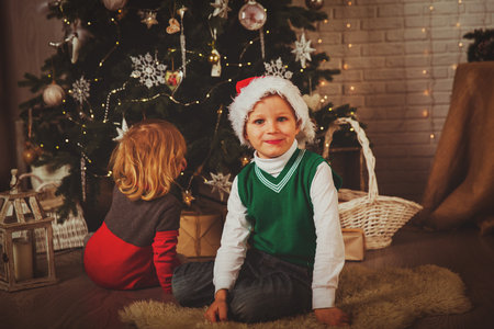 little boy and girl decorating Christmas tree, family Christmas celebrationの写真素材