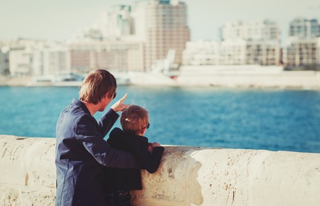 family travel-father and little son travel in the city looking at modern buildingsの写真素材