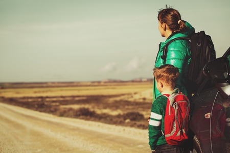 family travel - mother and little son with car on the roadの写真素材