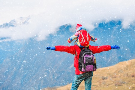 happy father and little daughter travel in winter mountainsの写真素材