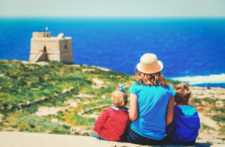 family travel concept-mother with two kids looking at scenic view in Malta, Europeの写真素材