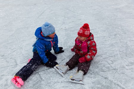 happy little boy and girl skating together, winter kids sportの写真素材