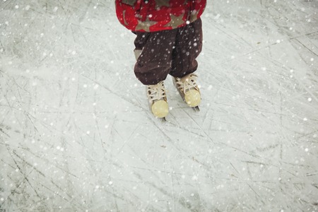 child feet learning to skate on ice in winter, kids winter sportの写真素材