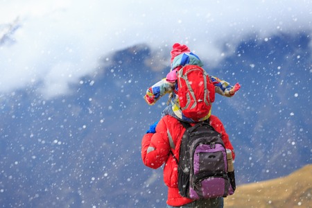 father and little daughter travel in winter mountains, family travel