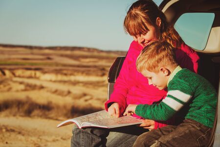 mother and son looking at map while travel by car in natureの写真素材
