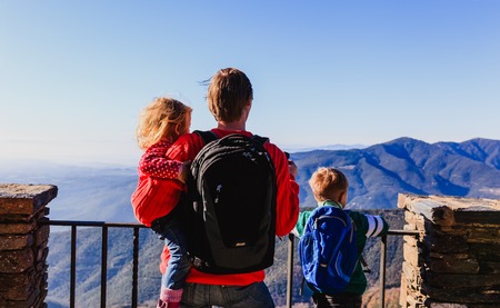 father with two kids travel in mountains, family travelの写真素材