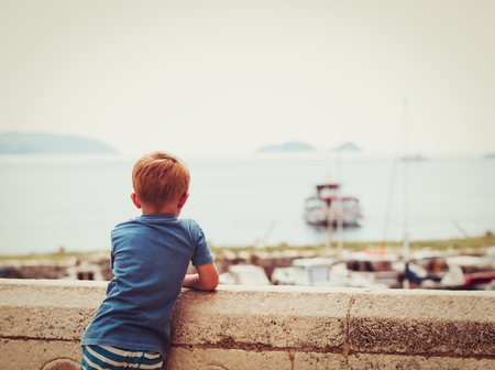 little boy looking at boats in Dubrovnik, Croatia, kids travel conceptの写真素材