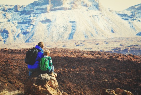 father and son hiking in mountains