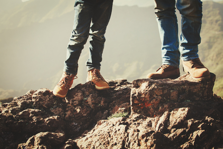 father and son hiking boots in mountainsの写真素材