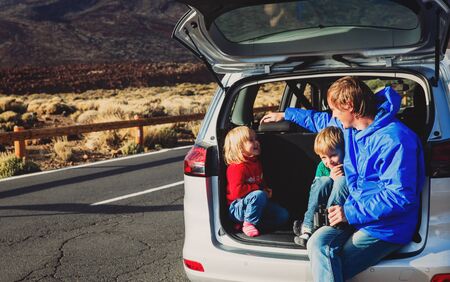 family travel by car- happy father with kids on roadの写真素材