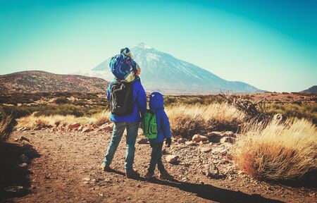 father with two kids travel in mountainsの写真素材