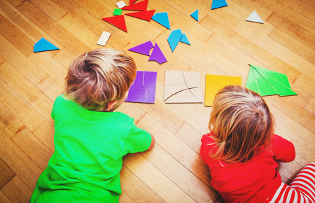little boy and girl playing with geometric shapesの写真素材