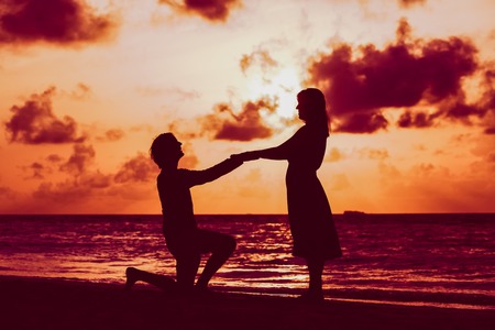 Marriage proposal at sunset beachの写真素材