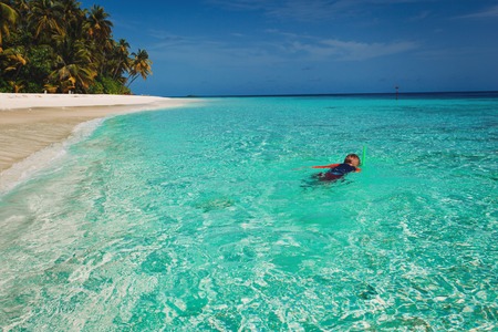 Little boy snorking on tropical beachの写真素材