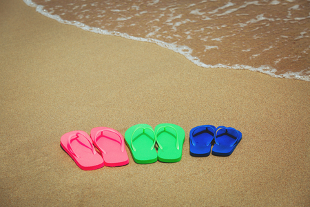 family beach flip flops at seaの写真素材