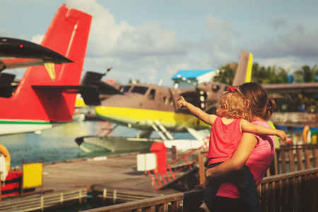 mother and little daughter waiting for seaplaneの写真素材